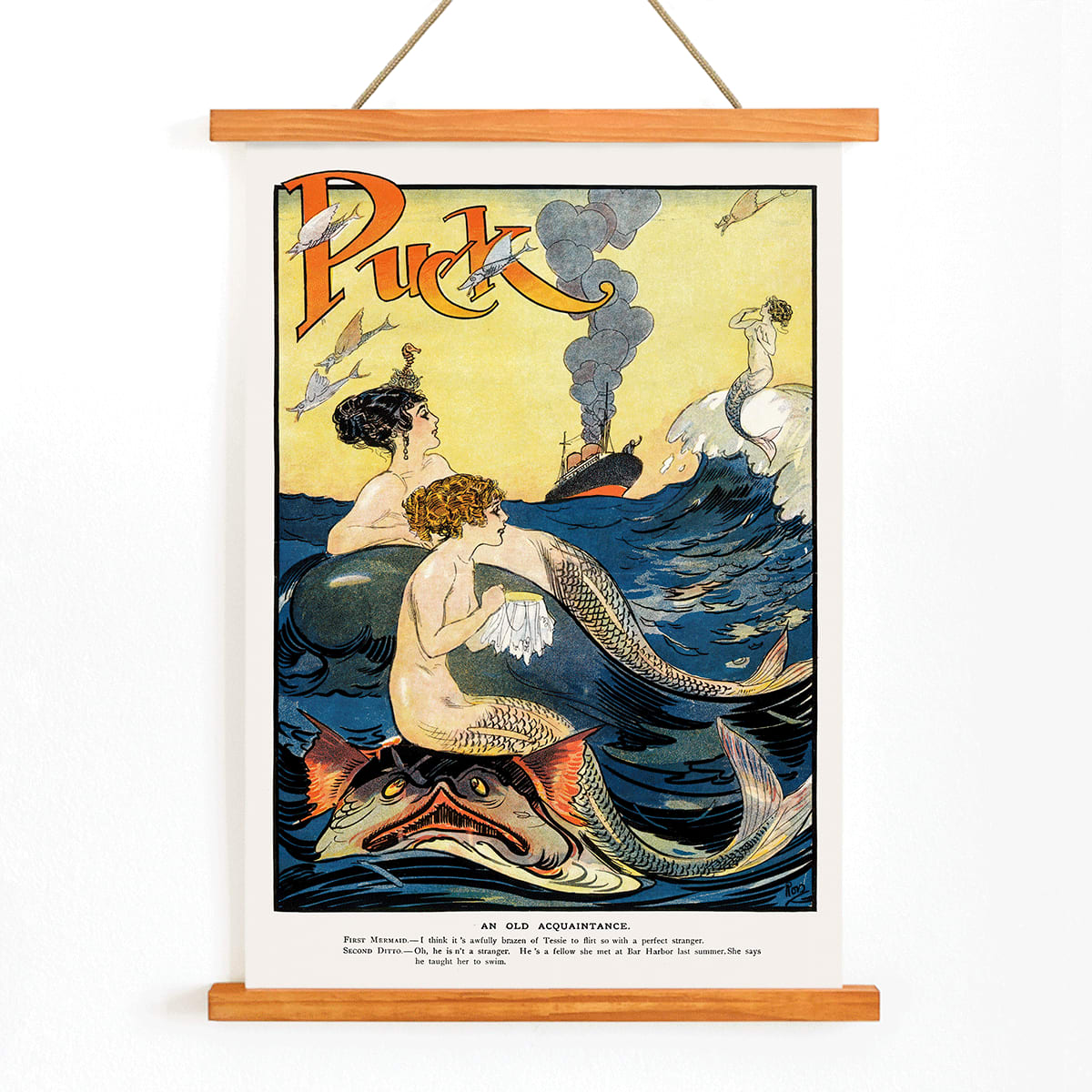 Vintage Puck Magazine illustration of mermaids sewing in a vibrant ocean scene with a boat in the background by Louis M Glackens and anonymous artist, with wooden magnetic frame on white background
