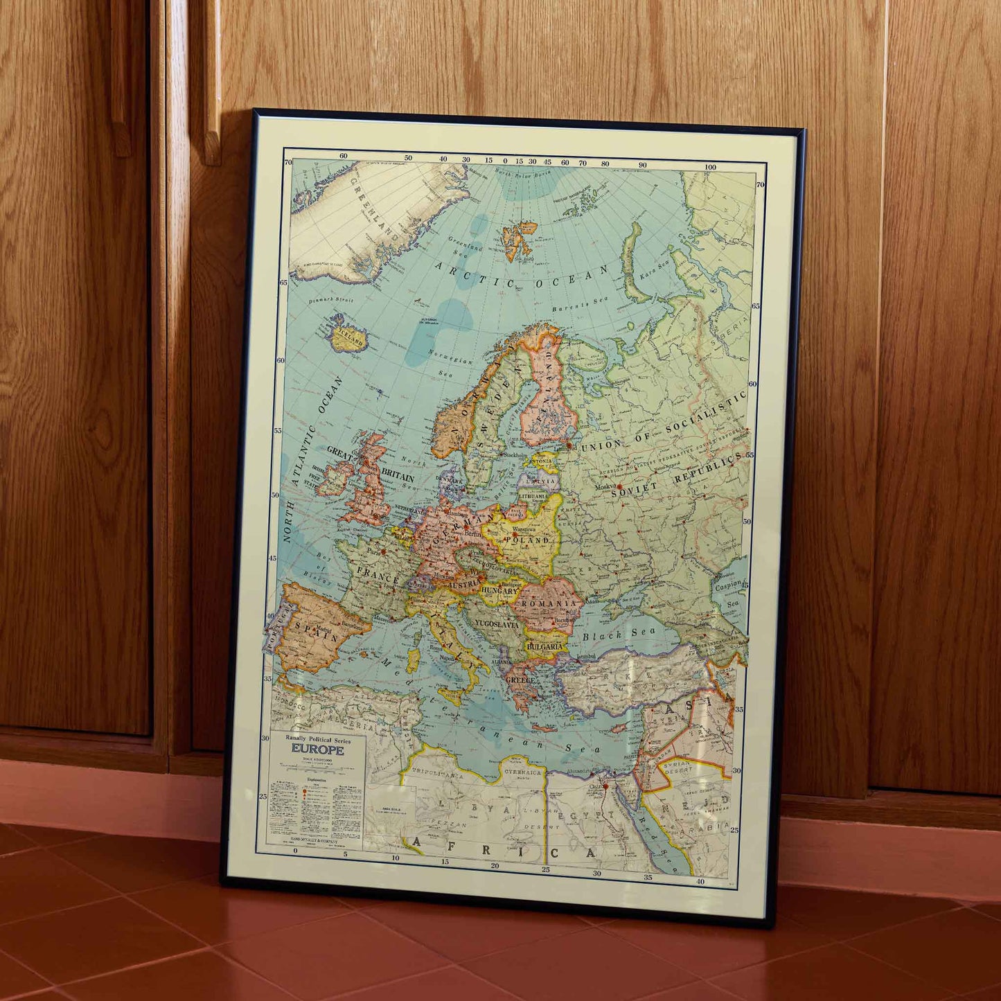 Rand McNally and Company Political Map of Europe poster with detailed continental map, colored borders, seas, and vintage cartographic typography, with wooden magnetic frame on white background