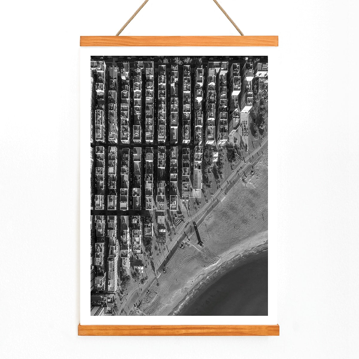 Aerial cityscape and black and white poster of Barceloneta beach and city grid aerial view, with wooden magnetic frame on white background