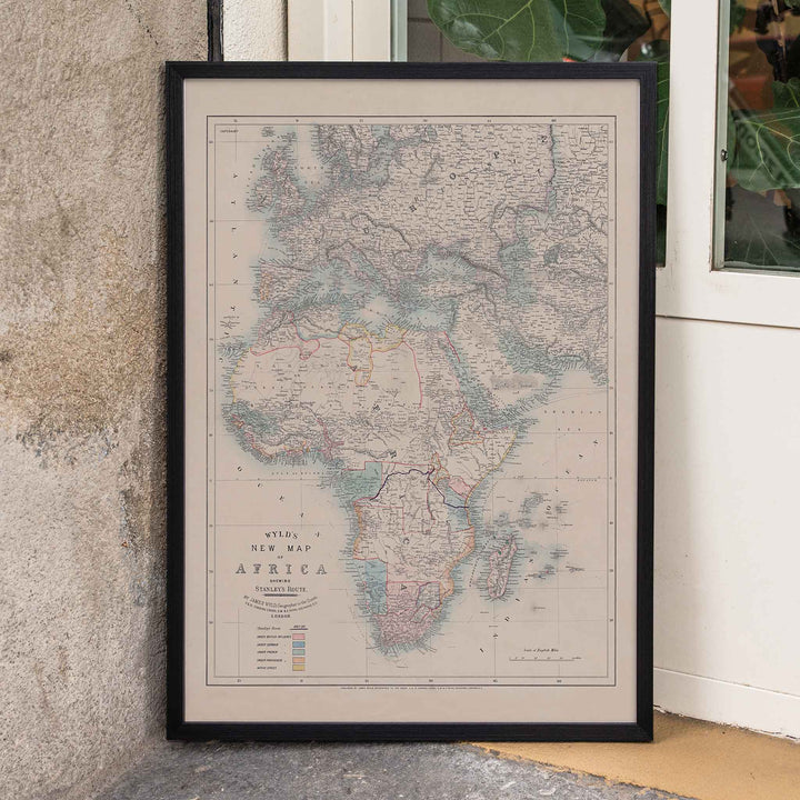 Wyld New Map of Africa vintage cartographic poster in beige grey blue and red tones, framed and displayed in home decor