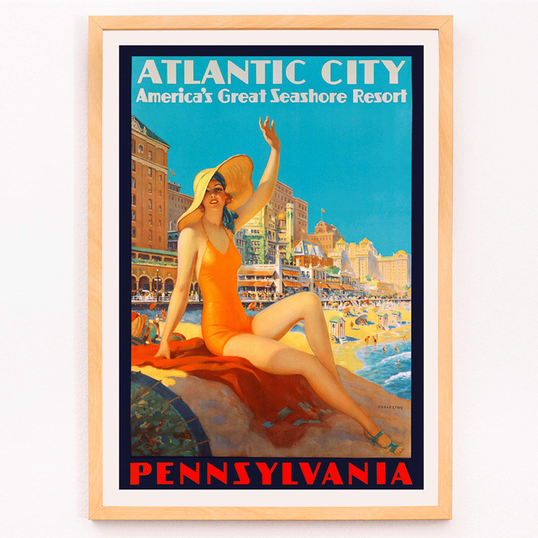 Atlantic City beach scene and Pennsylvania Railroad poster by Edward M Eggleston featuring woman in orange swimsuit at beach resort, framed and displayed in modern living room decor