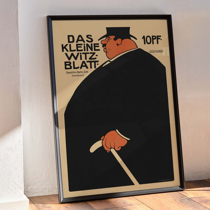 Julius Klinger Das kleine Witzblatt poster with bold black silhouette orange face and hand on beige minimalist background, framed and displayed in modern living room decor