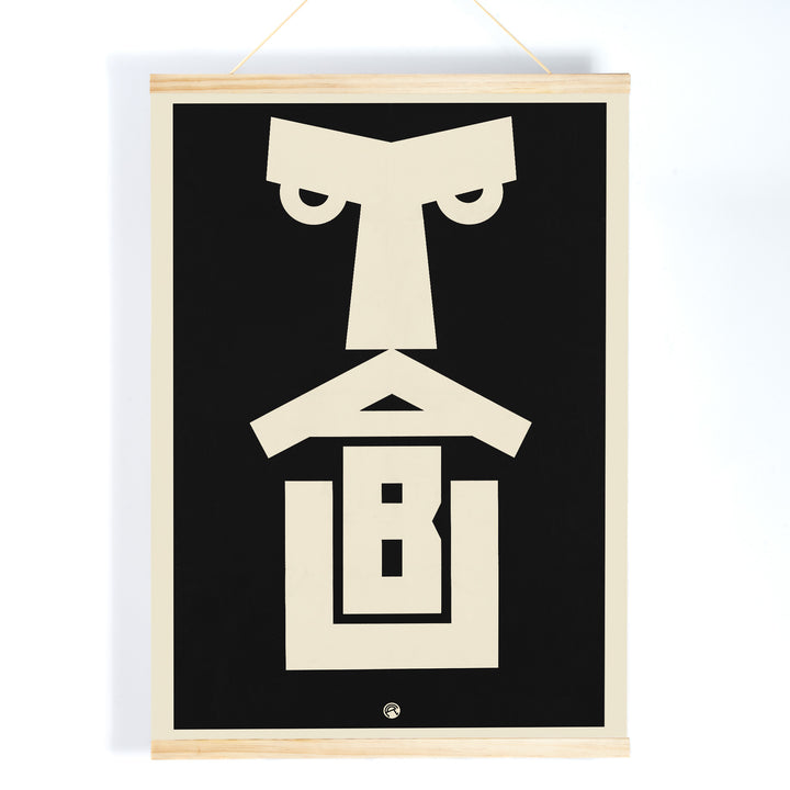 Julius Klinger Tabu poster with bold black and cream abstract geometric face in minimalist vertical design, with wooden magnetic frame on white background