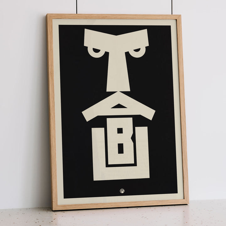 Julius Klinger Tabu poster with bold black and cream abstract geometric face in minimalist vertical design, framed and displayed in modern living room decor
