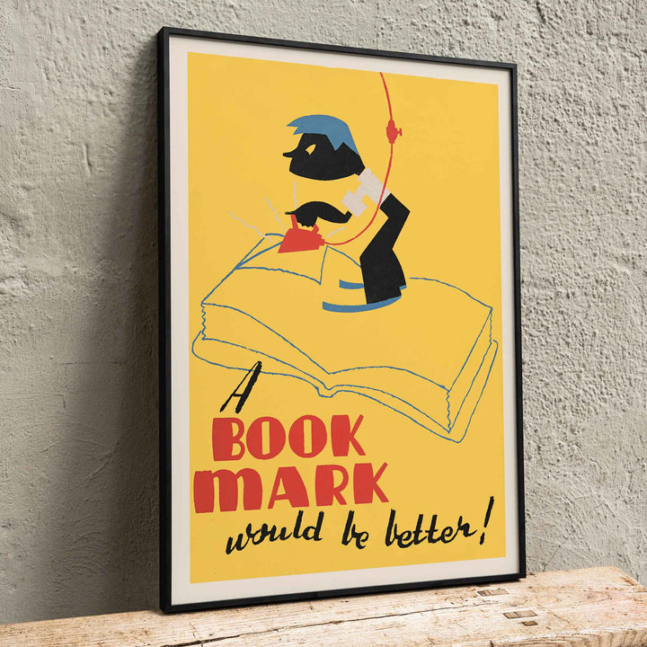 Arlington Gregg A Book Mark Would Be Better poster with stylized open book yellow background and bold red lettering, framed and displayed in home decor
