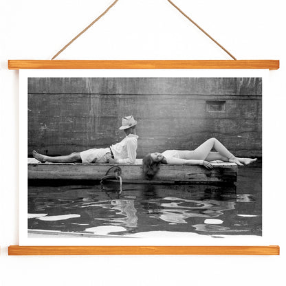 Marquess of Tavistock Henry Robin Ian Russell and Henrietta Tiarks relaxing on a dock in Bermuda by Toni Frissell poster, with wooden magnetic frame on white background