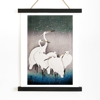 Group of egrets standing together in the snow artwork by Ohara Koson poster, with wooden magnetic frame on white background