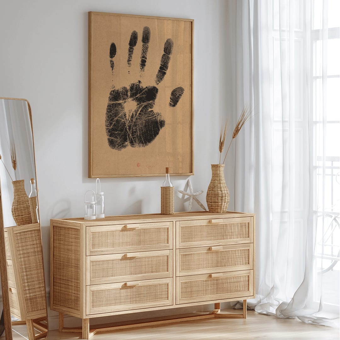Black ink handprint artwork titled The Artists Left Hand by Henri Charles Guerard on beige background, framed and displayed in home decor