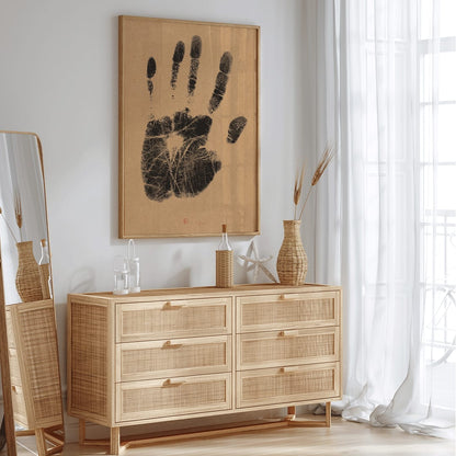 Black ink handprint artwork titled The Artists Left Hand by Henri Charles Guerard on beige background, framed and displayed in home decor