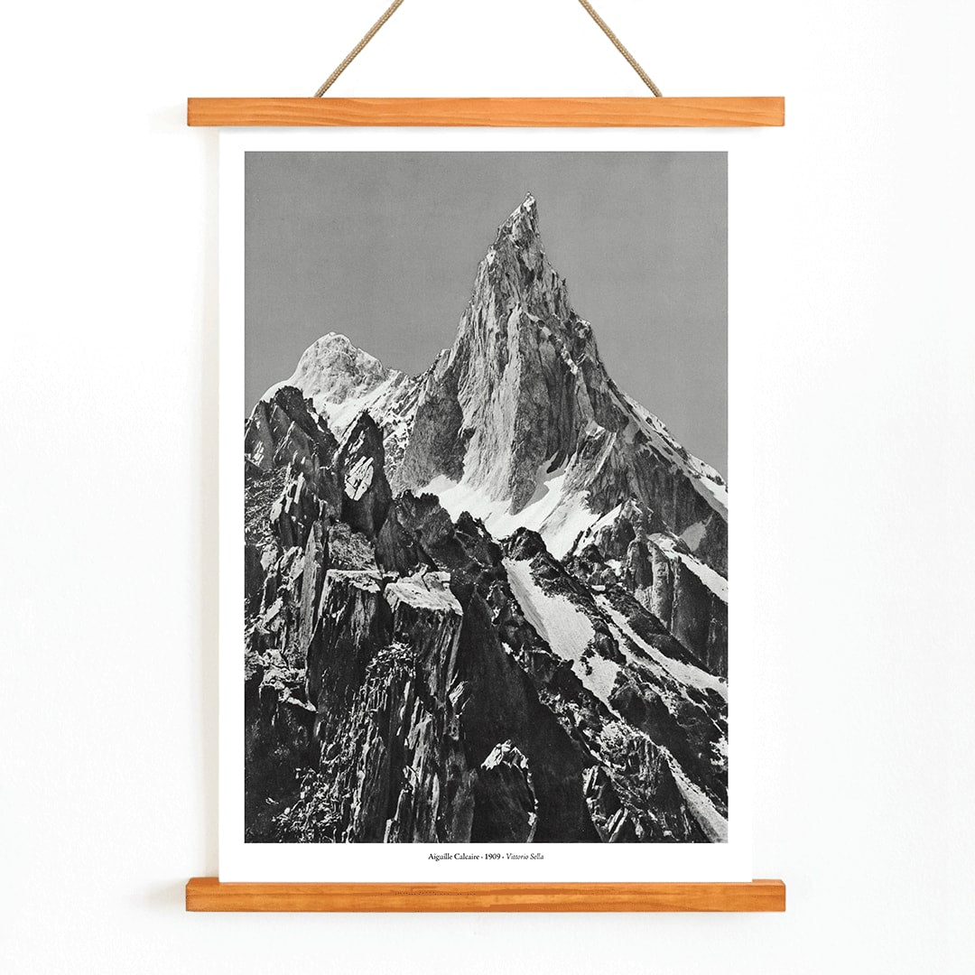 Jagged mountain peak with snow and glaciers by Vittorio Sell Aiguille calcaire Baltoro and Godwin Austen poster photography, with wooden magnetic frame on white background