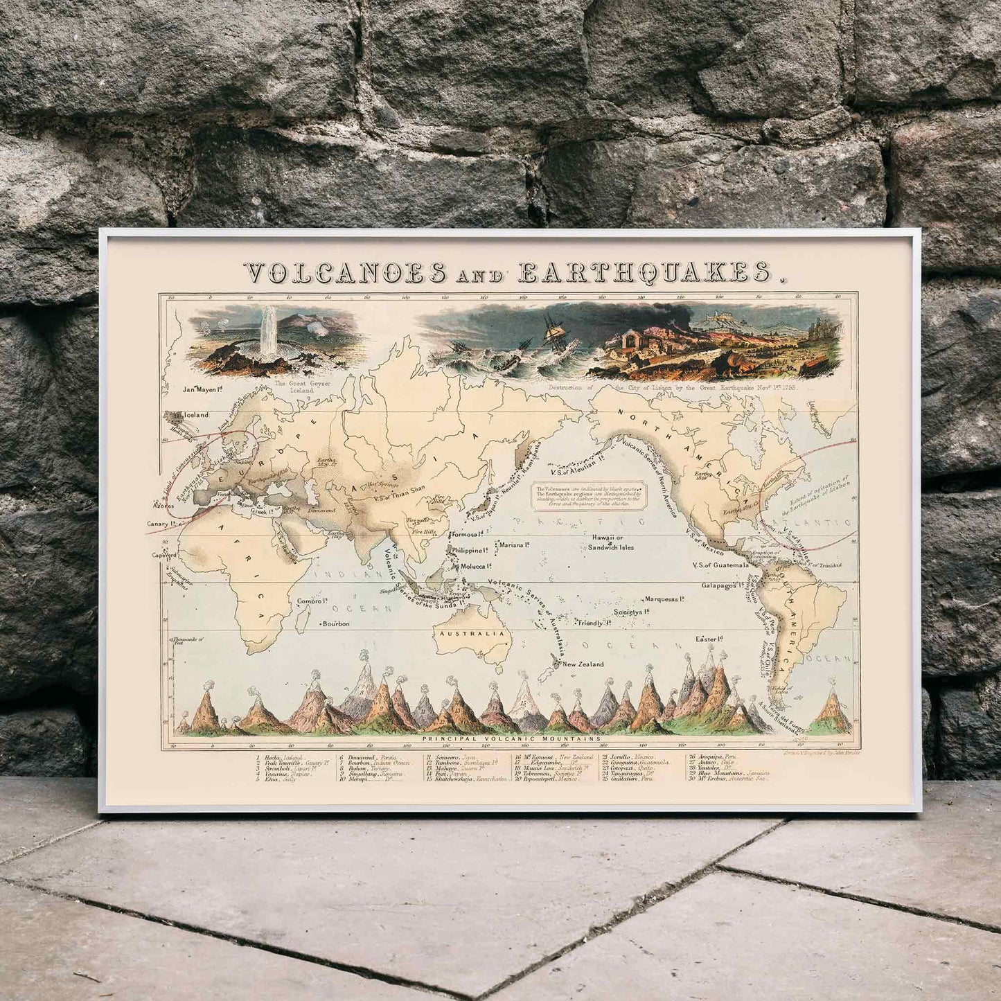 Map and poster illustration of volcanic and earthquake zones by James Reynolds titled Phenomena of Volcanoes and Earthquakes, framed and displayed in home decor