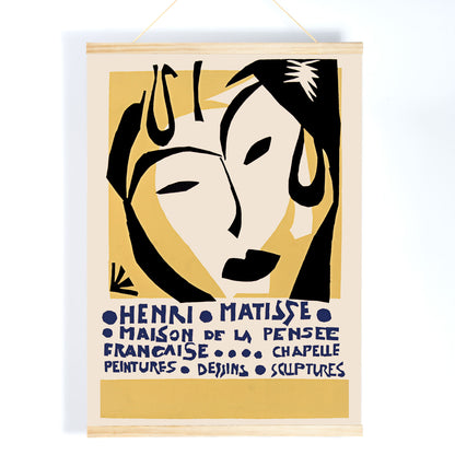 Henri Matisse Maison de la Pensee francaise poster with bold black abstract face shapes on warm yellow and cream minimalist design, with wooden magnetic frame on white background