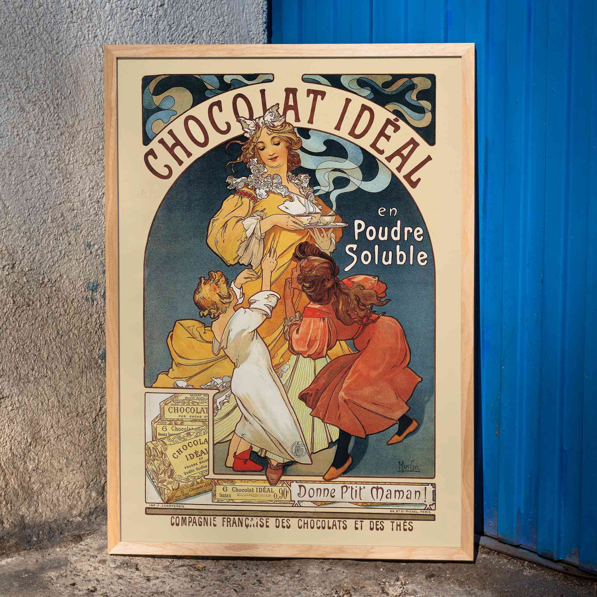 Vintage Art Nouveau poster Chocolat Ideal by Alphonse Mucha showing a woman serving hot chocolate to joyful children, framed and displayed in home decor