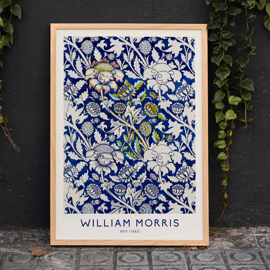 Floral fabric pattern and watercolour poster with intricate blue and white design by William Morris Wey, framed and displayed in home decor