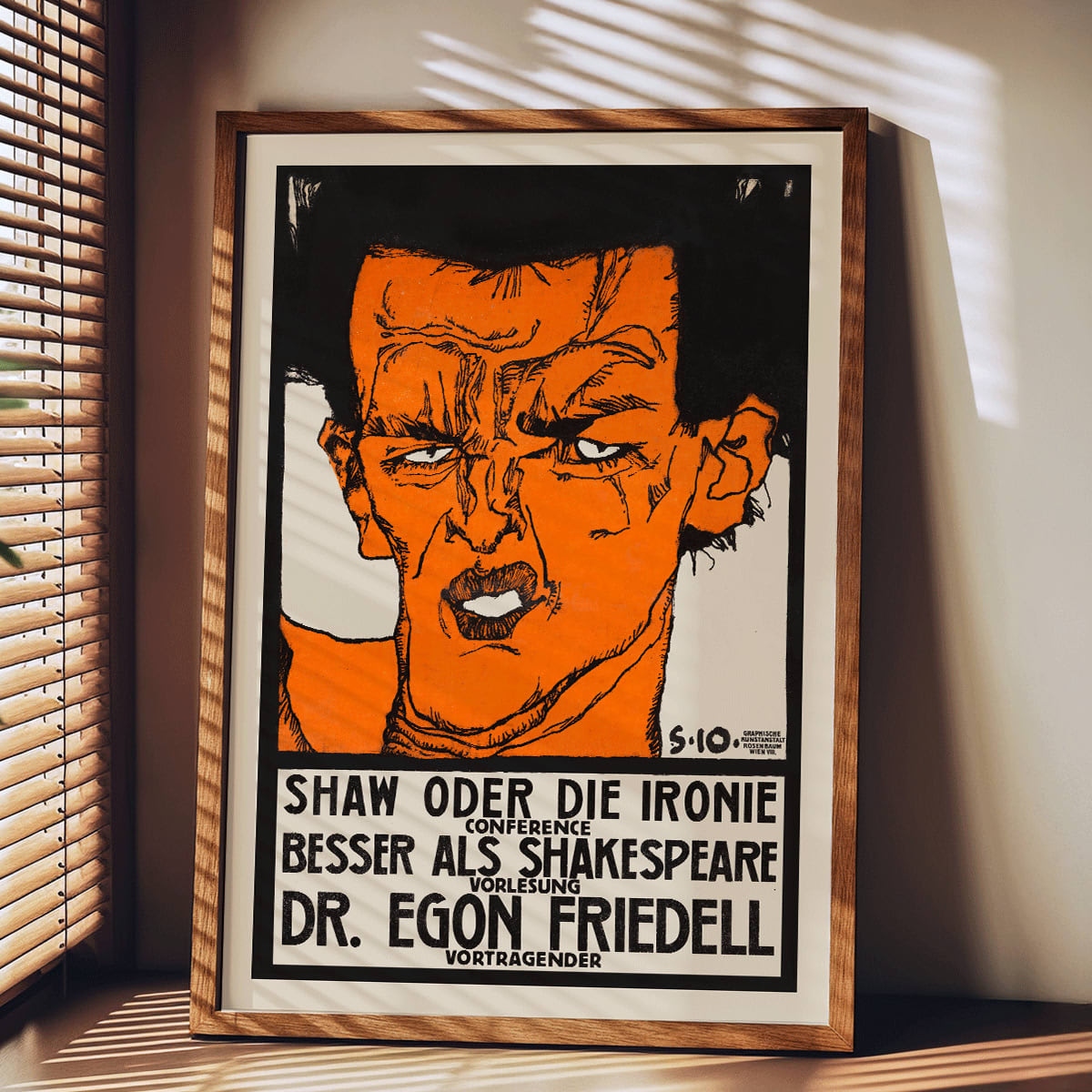 Colorful abstract portrait poster by Egon Schiele titled Shaw or Irony Lecture by Egon Friedell with bold colors and text, framed and displayed in modern living room decor