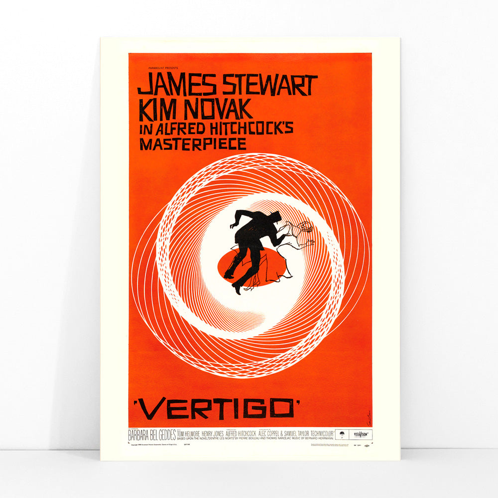 Vertigo movie poster by Saul Bass featuring vibrant orange background swirling spiral and silhouetted figures graphic design, framed and displayed in modern living room decor