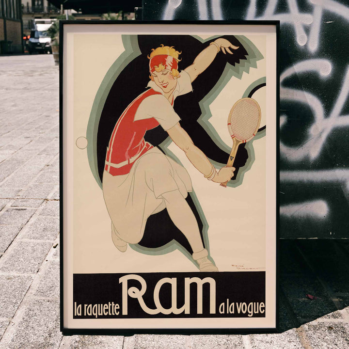 René Vincent La raquette Ram a la vogue vintage poster featuring a tennis player with racquet in red and cream, framed and displayed in modern living room decor
