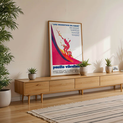 Pacific Vibrations surfing documentary poster by John Severson featuring colorful surfer illustrations and a surfer riding a wave, framed and displayed in modern living room decor