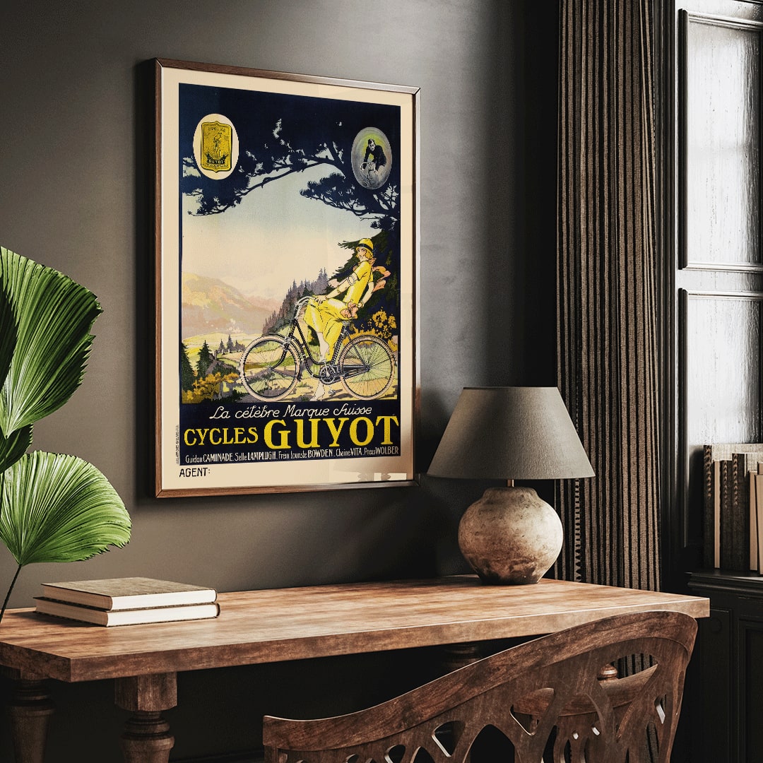 Woman in yellow riding a bicycle through a scenic landscape Cycles Guyot vintage poster artwork, framed and displayed in home decor